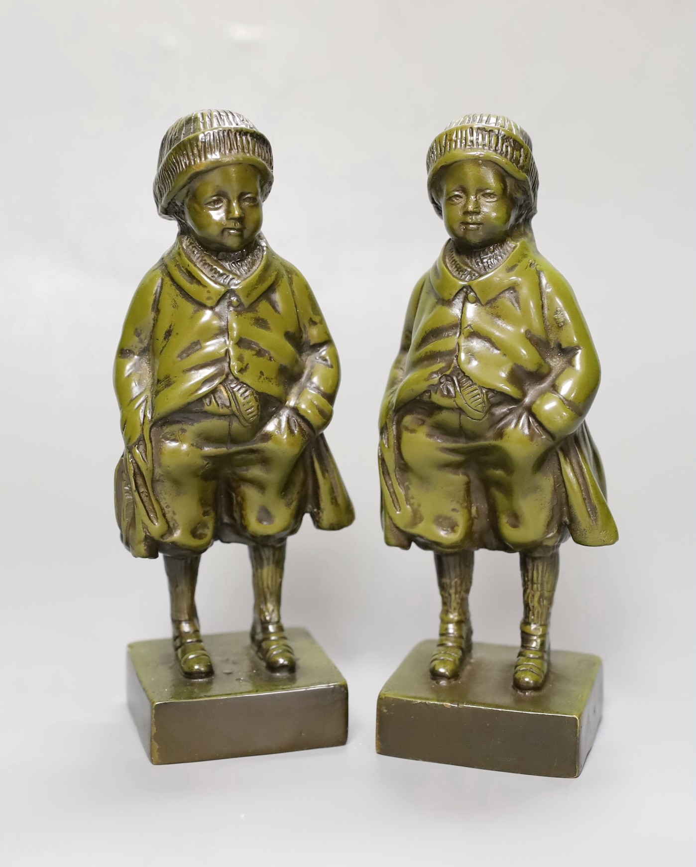 Two green patinated bronze figures of a boy. 18.5cm